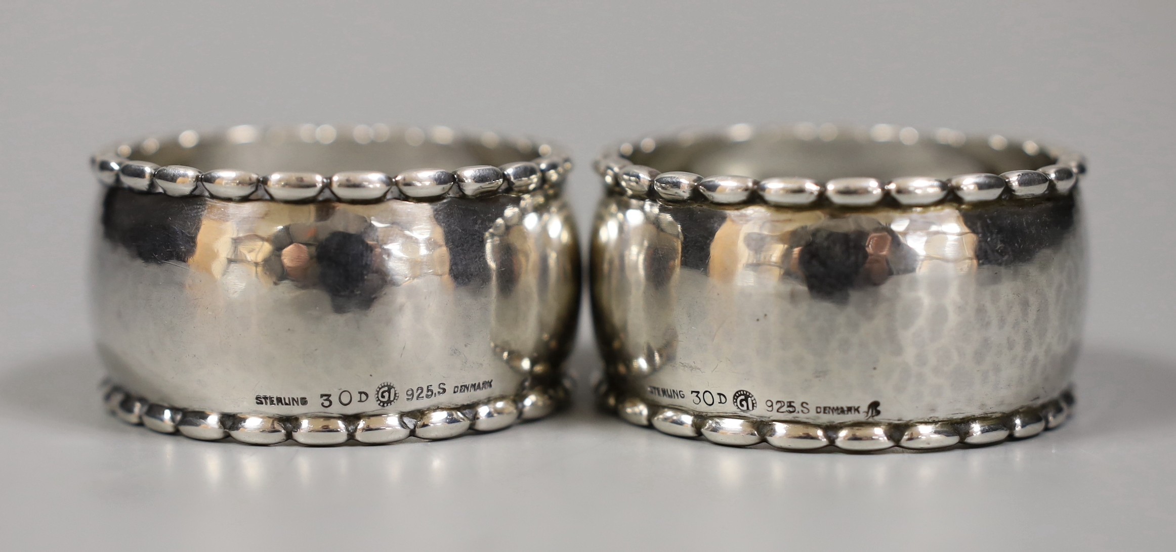 A pair of Georg Jensen sterling napkin rings, numbered 30D, 54mm.
